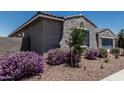 Stucco home with blue shutters and desert landscaping; a charming and well-maintained exterior at 17980 W Meadowbrook Ave, Goodyear, AZ 85395