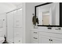 The bathroom features a glass-enclosed shower and white vanity with black hardware at 1800 S Jesse Pl, Chandler, AZ 85286