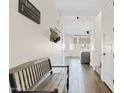 A hallway with a bench seat and decor leads to the living room at 1800 S Jesse Pl, Chandler, AZ 85286