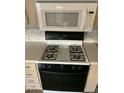 Close up of a black and white oven and microwave in the kitchen area at 201 S Greenfield Rd # 118, Mesa, AZ 85206