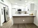 Lovely kitchen with a breakfast bar, white cabinets, and stainless steel refrigerator at 20917 N 37Th Pl, Phoenix, AZ 85050