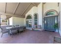 Relaxing outdoor seating area with an outdoor table set, a welcome bench, and an inviting entryway at 3611 E Dartmouth Cir, Mesa, AZ 85205