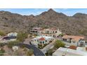 An aerial view of multiple luxury homes with red tile roofs nestled in the Arizona desert foothills at 3800 E Lincoln Dr # 54, Phoenix, AZ 85018