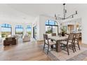 Open-concept living area with hardwood floors, large windows, and stylish furniture creates a bright, inviting space at 3800 E Lincoln Dr # 54, Phoenix, AZ 85018