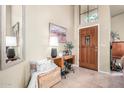 Bright foyer with a decorative table and a tall ceiling that creates an open and airy feel at 3828 N Rosewood Ave, Avondale, AZ 85392
