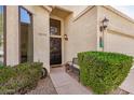 Inviting front entrance with a decorative door, sleek bench, and neat landscaping for curb appeal at 3828 N Rosewood Ave, Avondale, AZ 85392