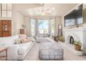 Spacious living room with a large window, fireplace, and comfortable seating for relaxation at 3828 N Rosewood Ave, Avondale, AZ 85392