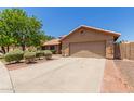 Single-story home featuring a spacious driveway, manicured landscaping, and a neutral-toned facade at 408 W Stacey Ln, Tempe, AZ 85284