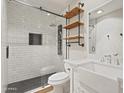 Modern bathroom featuring a walk-in shower with black hardware, wood shelving and a stylish white vanity at 4212 W Tierra Buena Ln, Phoenix, AZ 85053