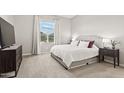 Serene bedroom featuring a large window, plush carpeting, and a stylish upholstered headboard at 4302 E Cynthia St, Gilbert, AZ 85295