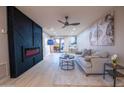 Modern living room with fireplace, stylish decor, and sliding glass doors at 4303 E Cactus Rd # 128, Phoenix, AZ 85032