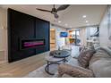 This living room features a modern fireplace, fan, and stylish decor at 4303 E Cactus Rd # 128, Phoenix, AZ 85032