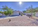 Charming single-story home featuring a low-maintenance yard, desert landscaping and a two-car garage at 522 W Dennis Ct, Tempe, AZ 85283