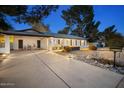 Well-maintained single-story home with clean lines, covered parking, a paved driveway, and xeriscaped front yard at 5338 E Hearn Rd, Scottsdale, AZ 85254