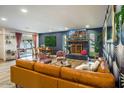 Comfortable living room with fireplace, large sofa, dining area access, and stylish accent wall at 5338 E Hearn Rd, Scottsdale, AZ 85254