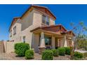 View of a two story home with stucco siding, a covered entrance and desert landscaping at 5516 N 193Rd Ave, Litchfield Park, AZ 85340
