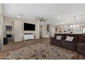 Open-concept living room with wood floors, recessed lighting, modern ceiling fan, and access to kitchen at 5516 N 193Rd Ave, Litchfield Park, AZ 85340