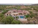 Luxury home with pool, lush landscaping, covered patio, and views at 7254 E Sonoran Trl, Scottsdale, AZ 85266