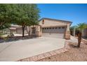 Charming single-story home with a spacious driveway, two-car garage, and well-manicured landscaping, perfect for families at 874 E Lamonte St, San Tan Valley, AZ 85140
