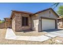 Charming single-story home featuring a two-car garage and stone veneer accents, creating an inviting curb appeal at 923 E Randy St, Avondale, AZ 85323