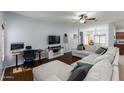 Open-concept living room with hardwood floors, a ceiling fan, and natural light, perfect for relaxation at 923 E Randy St, Avondale, AZ 85323