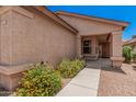 Inviting front entrance with desert landscaping, covered porch, and security door at 105 W Monona Dr, Phoenix, AZ 85027