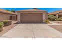 Single-car garage with a concrete driveway and low-maintenance landscaping in front at 105 W Monona Dr, Phoenix, AZ 85027