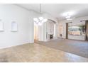 Bright living room boasts tile flooring and plush carpet, plus a cozy fireplace at 14436 W Ventura St, Surprise, AZ 85379