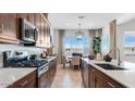 Modern kitchen featuring dark wood cabinets and stainless steel appliances at 15044 W Gray Fox Trl, Surprise, AZ 85387