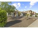 Inviting single-story home with a stone facade, desert landscaping, and an attached two-car garage at 15969 W Adams St, Goodyear, AZ 85338