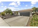 Attractive single-story home featuring a spacious driveway, large garage, and well-kept yard at 15969 W Adams St, Goodyear, AZ 85338