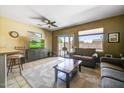 Bright living room features sliding glass door, tile flooring, and comfortable seating at 16469 W Century Plant Dr, Surprise, AZ 85387