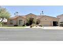 Charming single-story home featuring a well-manicured lawn, desert landscaping and a terracotta tile roof at 2053 E Clubhouse Dr, Phoenix, AZ 85048