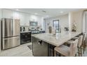 Modern kitchen features stainless steel appliances, spacious island, and bright white cabinets at 2109 W Berridge Ln, Phoenix, AZ 85015