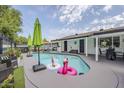 Sparkling pool with fun inflatables, surrounded by patio furniture, perfect for relaxation at 2109 W Berridge Ln, Phoenix, AZ 85015
