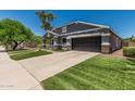 Charming home with manicured lawn, stone accents, and attached two car garage at 2542 E Los Alamos St, Gilbert, AZ 85295