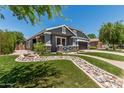 Beautiful front yard featuring rock landscaping, decorative grass, and well-maintained lawn at 2542 E Los Alamos St, Gilbert, AZ 85295