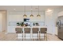 Modern kitchen featuring an island with barstool seating and stainless steel appliances at 3123 S 155Th Ln, Goodyear, AZ 85338