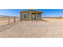 Inviting home featuring a well-maintained exterior and charming front porch at 32650 N 223Rd Dr, Wittmann, AZ 85361