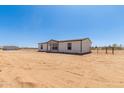 Well-maintained single-story home, featuring a fenced yard, with ample space at 32712 N 223Rd Dr, Wittmann, AZ 85361