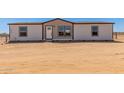 Charming single-story home with white siding, black trim, and a neatly landscaped front yard at 32712 N 223Rd Dr, Wittmann, AZ 85361