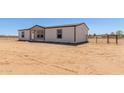 Well-maintained single-story home, featuring a fenced yard, with ample space at 32712 N 223Rd Dr, Wittmann, AZ 85361