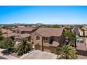 An aerial view showcases this well-maintained desert home with lush landscaping and a nearby community pool at 5060 S Clancy --, Mesa, AZ 85212