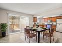 Open dining area with modern table set and access to the kitchen and outdoor space at 6625 N 44Th Ave, Glendale, AZ 85301