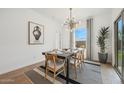Tastefully decorated dining room with a stylish light fixture and a view of the backyard at 7435 S 76Th Dr, Laveen, AZ 85339