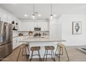 Bright, eat-in kitchen features a modern island with pendant lighting and stainless steel appliances at 7435 S 76Th Dr, Laveen, AZ 85339