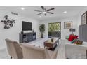 Inviting living room with comfortable seating, a large TV, and sliding glass doors to the balcony at 7777 E Main St # 215, Scottsdale, AZ 85251