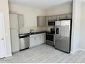 A modern kitchen with stainless steel appliances and ample cabinet space at 8330 N 22Nd Ln, Phoenix, AZ 85021