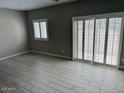 Living room featuring tiled flooring and a sliding glass door at 8330 N 22Nd Ln, Phoenix, AZ 85021