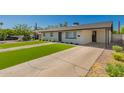 Well-kept home with green grass and cracked concrete driveway at 915 E Commonwealth Pl, Chandler, AZ 85225